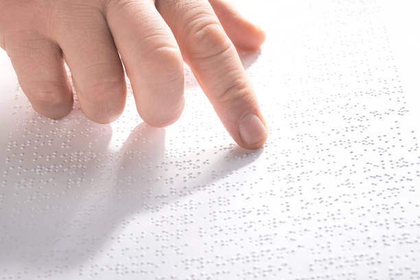 istock Hand of a blind person reading some braille text touching the relief. Horizontal 1226077503