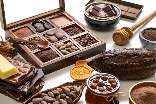 Chocolate wood box with cocoa pod and cacao beans and chocolate products on white background