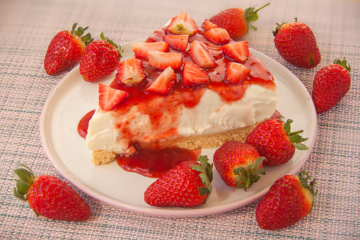 delicious cheesecake with strawberries on a plate