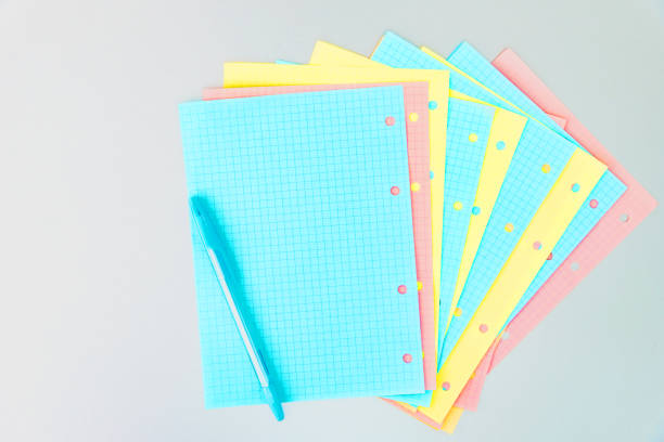 istock Multicolored sheets of blocks for booklet from a folding notebook in different pastel colors scattered on silver desk 1226080330
