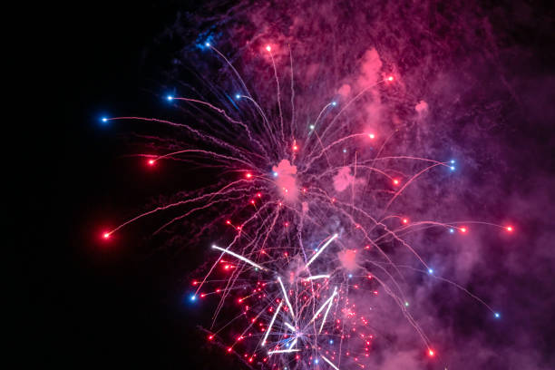 istock Blue Red and white fireworks with smoke over the city sky 1226080416