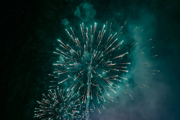 istock Green fireworks with smoke over the city sky 1226081008