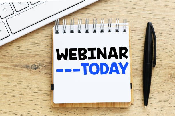 istock WEBINAR TODAY words written in a notebook on a wooden table. 1226083829