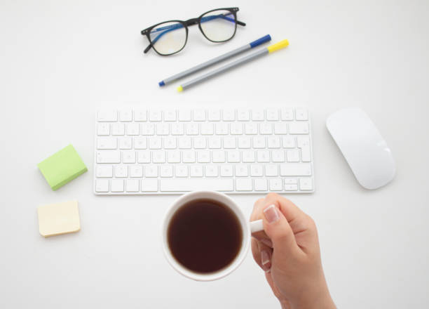 istock Take a break and drink tea. Topview office desktop. Keyboard, mouse, office materials. 1226083913
