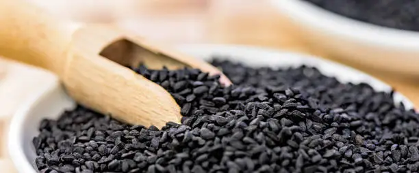 Black cummin seeds - natural antioxidant - closeup - banner design