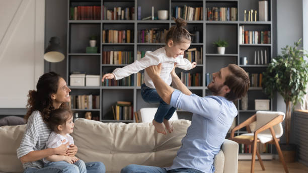 istock Overjoyed parents have fun play with little daughters 1226087846