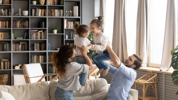 istock Happy parents have fun playing with small daughters 1226087848
