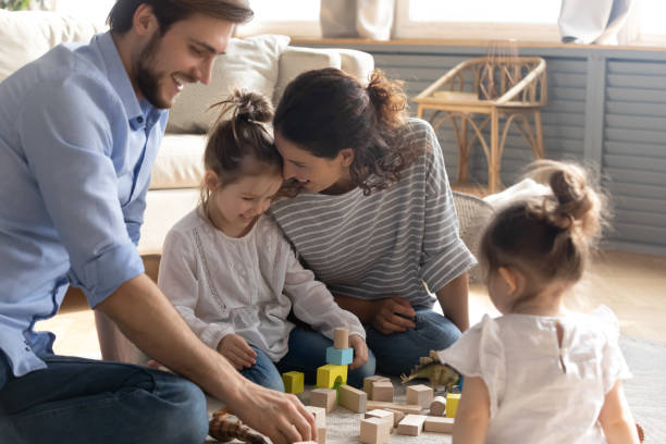 istock Happy young family with kids playing with bricks 1226087859