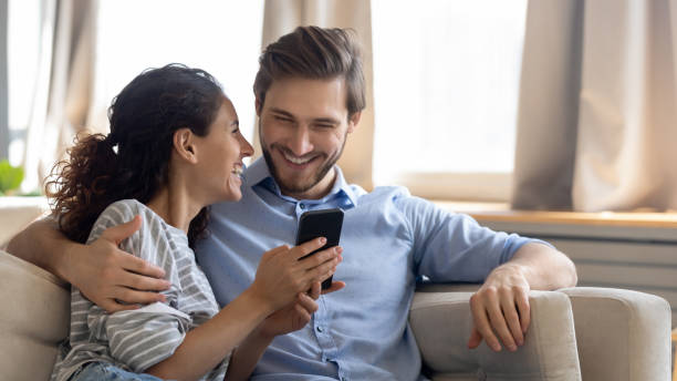 istock Happy young couple using modern smartphone together 1226087906