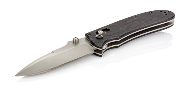 istock Lying open folding pocket knife with satin blade and black composite plastic cover plates on steel handle isolated on white background with reflection on glossy surface. Pocket knife close-up image 1226092829