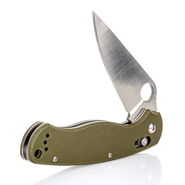 istock Open folding pocket knife with matte blade and textured dark green composite plastic cover plates on steel handle isolated on white background with reflection on glossy surface. Pocket knife close-up 1226092858
