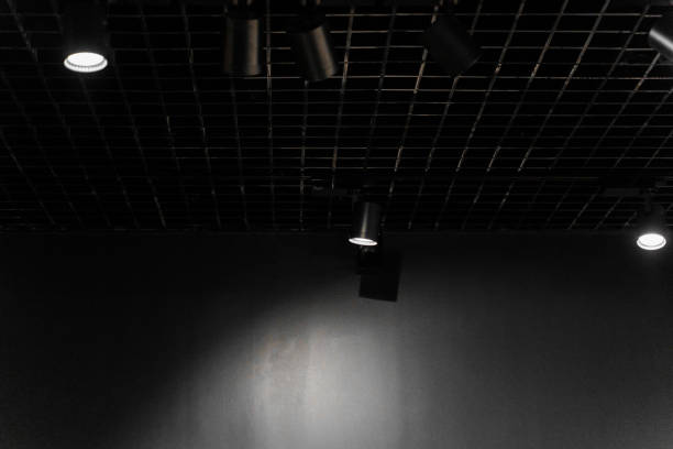 Lights system on dark ceiling of the office industrial black building, exhibition hall with led smart light. Ceiling construction