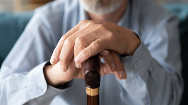 istock Close up elderly mature man leaning hands on walking cane. 1226093649