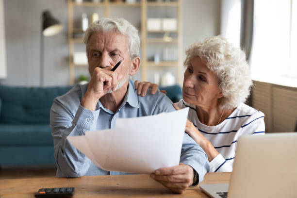 Unhappy depressed family married couple having financial trouble. Compassionate elderly woman supporting upset stressed mature husband, received bad news banking letter. Unhappy depressed family married couple having financial trouble, got house eviction notice. eviction photos stock pictures, royalty-free photos & images