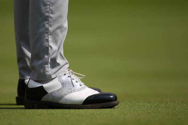 Black & White golf shoes. Black & White golf shoes seen on the putting green. sports photography stock pictures, royalty-free photos & images
