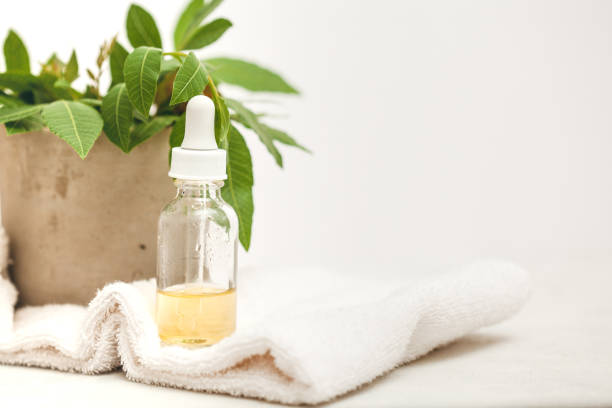 istock Glass face serum bottle on white towel. Skin care routine, 1226094852