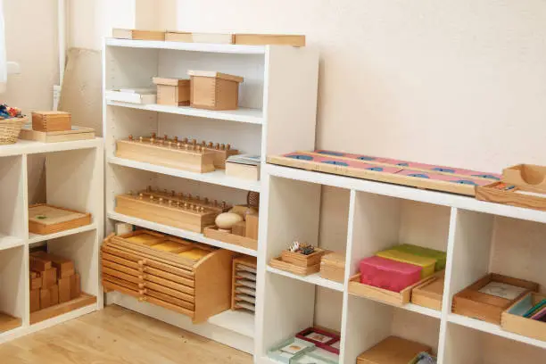 Montessori wood material for the learning of children. Shelving in a Montessori class.