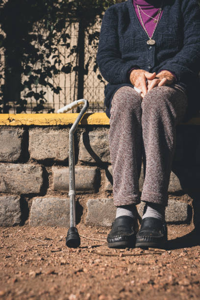 istock A senior lady sitting on a park bench in the sun. 1226099127