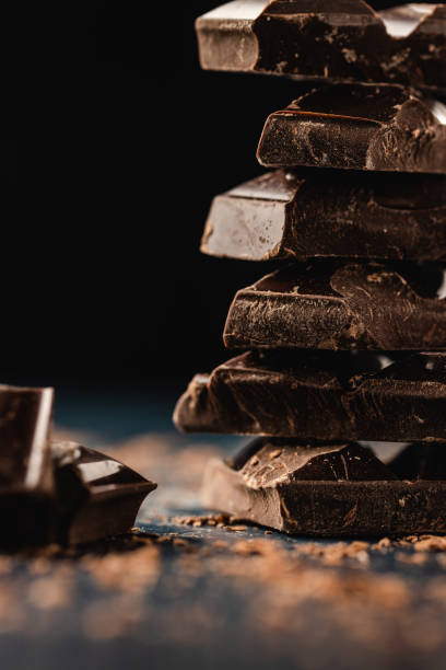 istock Stack of dark chocolate pieces on dark background. Close-up. Copy space. 1226099205