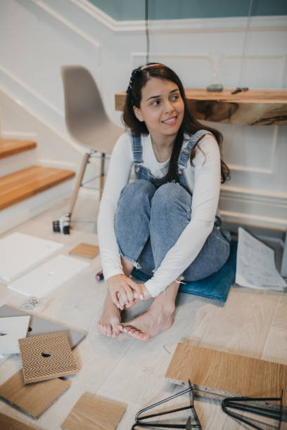 istock Woman Assembling Wooden Cabinet in Home 1226099908