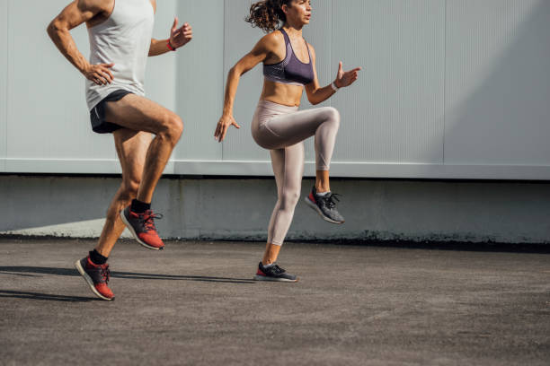 istock Urban Runners: Fit Man and Woman Running Outdoors Together 1226100888
