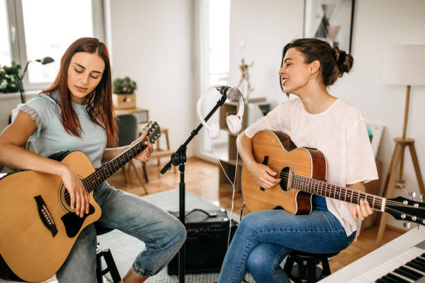 istock Two young female musicians playing guitars. 1226103140