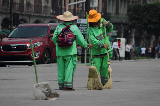 Street sweeper during his work day on the Zocalo in Mexico City. Mexico City / Mexico - October 2019: Street sweeper during his work day in the pinth of the city. Mexicans do not have a culture of cleaning and this job may be very hard in big cities like this. The Zocalo. street sweeper stock pictures, royalty-free photos & images