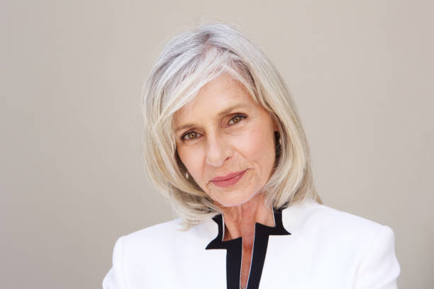 istock beautiful older woman staring standing by wall 1226105790