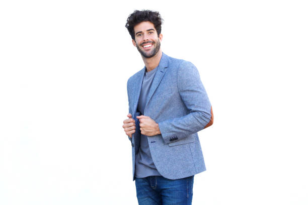 istock Handsome man standing in blue blazer smiling by white wall 1226105812