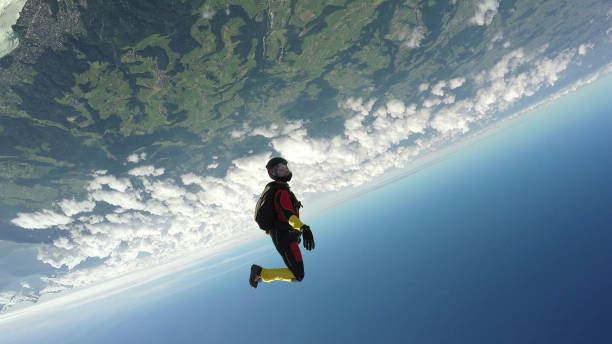 istock Female skydiver falls through clear skies, aerial flight 1226106479