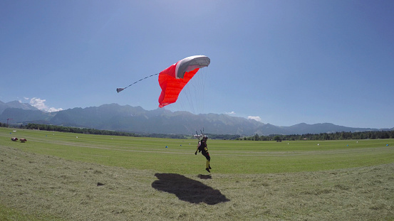 A man paragliding in the blue sky