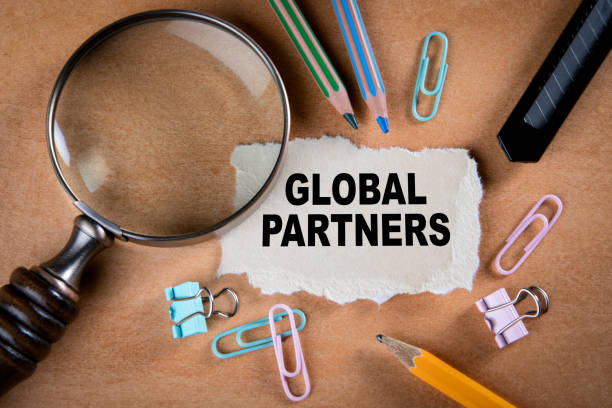 istock GLOBAL PARTNERS concept. Magnifying glass, stationery and note paper 1226107260