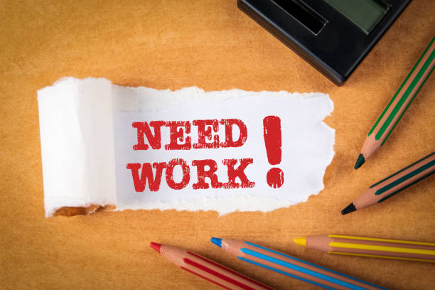 istock NEED WORK concept. Text under torn paper. Pencils and office supplies 1226107284