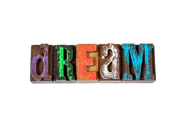 istock DREAM. Colored wooden letters on a white 1226107303