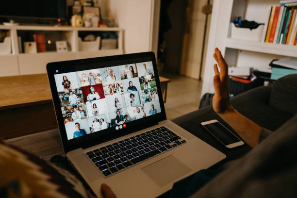 Young woman using a laptop on the sofa at home to have a work conference call