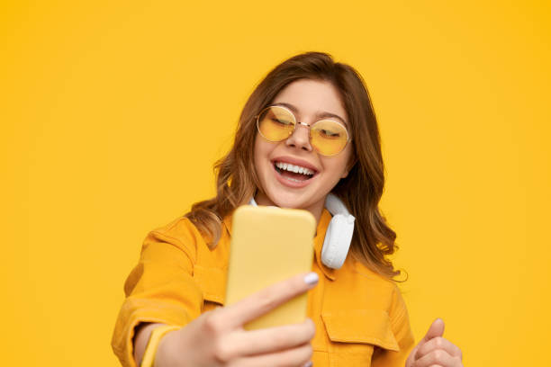istock Stylish woman smiling and taking selfie 1226111116