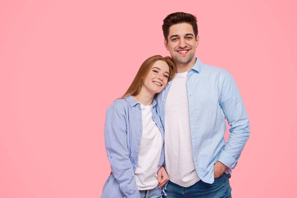 istock Young couple smiling and looking at camera 1226111162