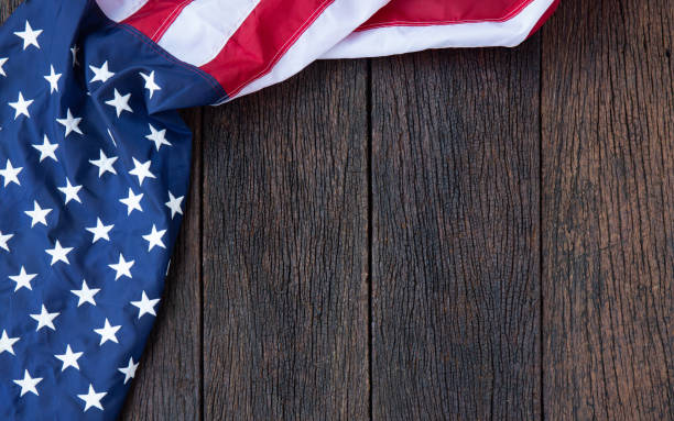 istock America flag waving pattern on wooden background in table top view, red blue white strip concept for USA 4th july independence day, symbol of patriot freedom and democracy. Glory pride in memorial day of liberty 1226111249