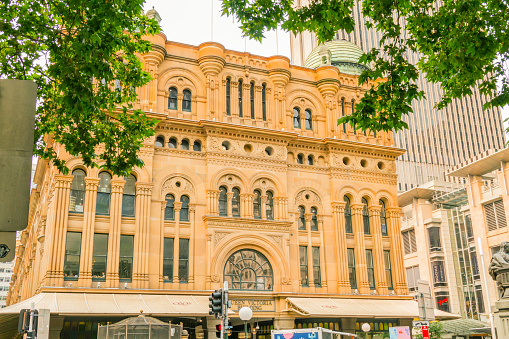 Sydney, Australia - December 30, 2019: People crossing the road outside exterior view of Queen Victoria Building or QVB shopping arcade in Sydney NSW Australia\n\nQueen Victoria building is the 19th ct. heritage listed marketplace, recently renovated and turned into a shopping gallery.\n\nCentral Business District - Queen Victoria Building