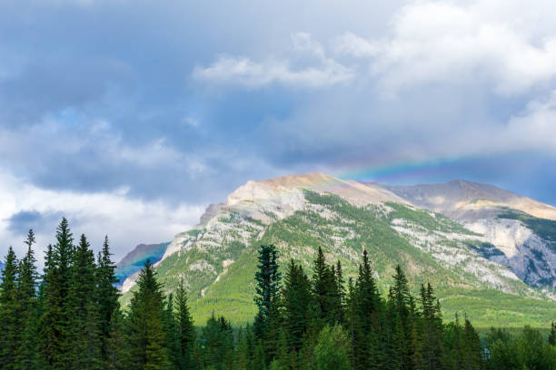 istock Beautiful mountain landscape with a rainbow cascading across the peak 1226112341