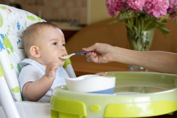 istock a little baby eating at home 1226117398