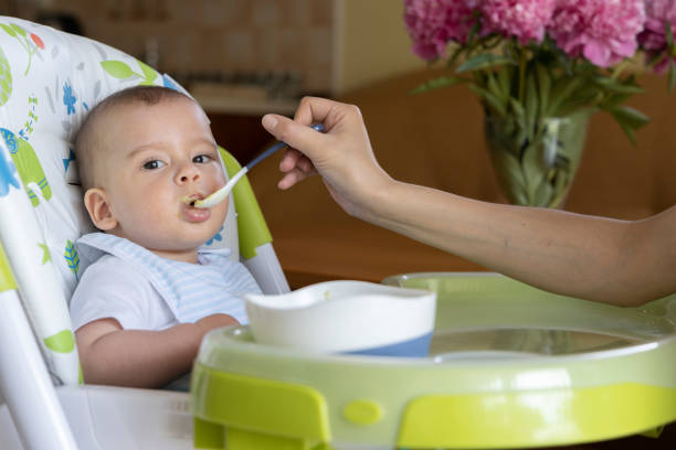 istock a little baby eating at home 1226117402