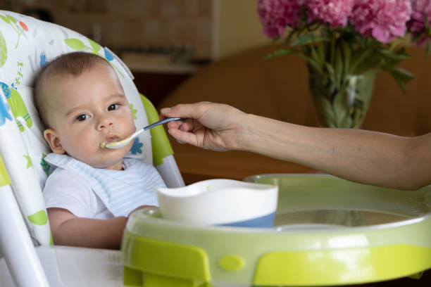 istock a little baby eating at home 1226117403