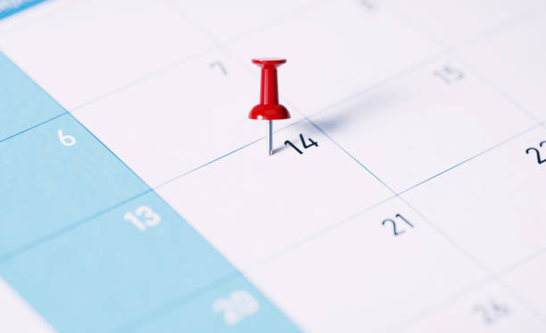 White calendar with red push pin to remind important dates. Calendar and reminder concept. Horizontal composition with copy space.