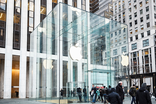 New York, New York, USA -  February 10, 2016: People standing in front of the Apple store on Fifth Avenue and 59th Street in Manhattan.
