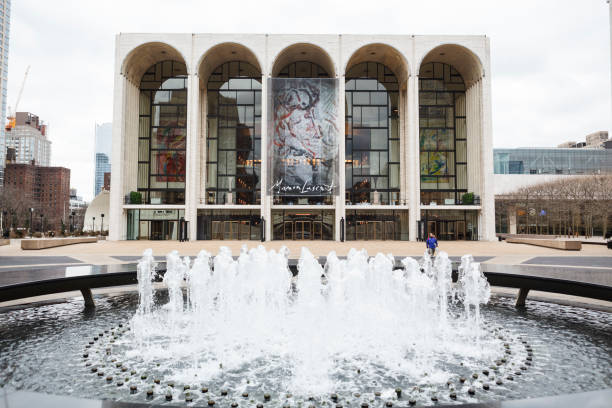 New York, New York, USA -  February 10, 2016: The world famous Metropolitan Opera House at Lincoln Center in Manhattan. People can be seen on the plaza around the fountain.