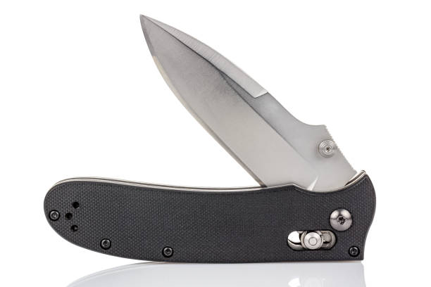 istock Open folding pocket knife with satin blade and textured black composite plastic cover plates on steel handle isolated on white background with reflection on glossy surface. Pocket knife close-up image 1226126709
