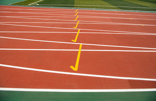 Sprint competition on running track. Finish line low angle view.