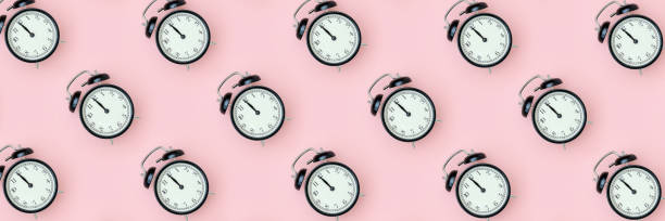 istock Pattern with black alarm clock on pink background. Minimal style Top view Banner Template for your text, design 1226128765
