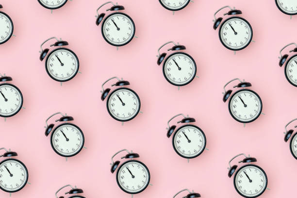 istock Pattern with black alarm clock on pink background. Minimal style Top view Template for your text, design 1226128775